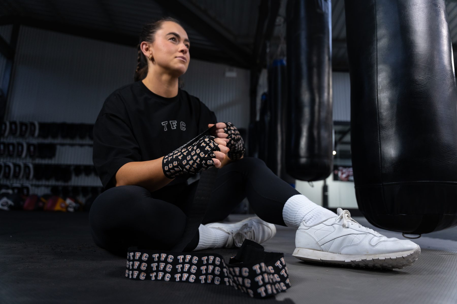 Fighter wrapping her hands in custom TFC gear before a training session